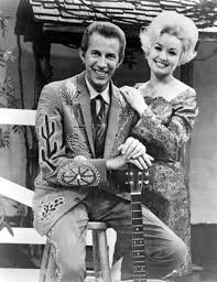 Dolly Parton 1967: Country singer Dolly Parton with her collaborator Porter  Wagoner on the set of his TV show in circa 1967. Mr. Wagoner is wearing a Nudie  Suit designed by Nudie
