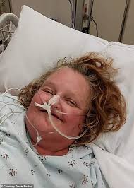 Woman who was found in wrecked car after going missing for five days smiles  from her hospital bed