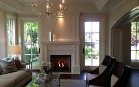Inspiration for a timeless open concept medium tone wood floor living room remodel in new york with gray walls, a corner fireplace, a wood fireplace surround and a media wall. Weather Resistant Door Coquitlam Exterior Doors French Doors Interior Wooden French Doors Wood Doors Interior