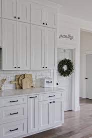 White cupboards black kitchen cabinets kitchen cabinet hardware black kitchens home kitchens shaker cabinets broom cabinet kitchen cabinetry cabinet handles. Modern Farmhouse Kitchen White Kitchen Shaker Cabinets White Cabinets Subway Ti White Shaker Kitchen Cabinets Home Decor Kitchen Farmhouse Kitchen Cabinets