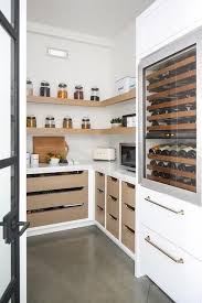 Wrap Around Gray Wood Pantry Shelves Are Stacked Above Gray Drawers Topped With A Statuary Quartz Countertop Pantry Design Kitchen Pantry Design Home Kitchens