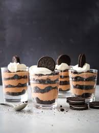Layered oreo pudding dessertseeded at the table. Easy Chocolate Oreo Parfaits Completely Delicious