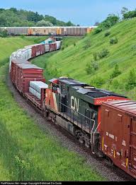 North American Economy On The Move Cn 369 S Mid Train Remote Is Seen In Full Throttle Helping With The Full On As Canadian National Railway Train Train Tracks