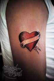 The trim of each bow is made of small white dots, framed by thin black lines. Red Ink Heart With Ribbon Tattoo On Right Half Sleeve