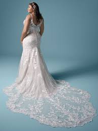 Sheer detailing and floral lace make this wedding dress a true showstopper. Long Train Wedding Dresses For An Extra Glamorous Occasion