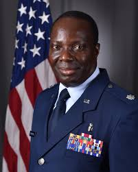 CONGRATULATIONS!!! Guam Air National Guard's Col. Johnny Lizama sports a  smile as Gov. Eddie Calvo, left, and his wife, Doris "Dee" Lizama pins  stars