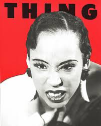 The cover of the Spring 1991 issue of THING, featuring Pam Johnson,  photographed by Steven Winter. Pictured: A black and white photo of Pam  Johnson wearing feather earrings and staring intensely at