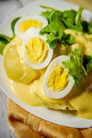 The creamy spicy sauce is poured over cold slices of potato. Papa A La Huancaina Peruvian Potatoes And Hard Boiled Eggs With Spicy Aji Amarillo Yellow Sauce Stock Photo Picture And Royalty Free Image Image 103179678