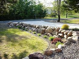 How To Build A Boulder Rock Retaining Wall Ehow Landscaping Retaining Walls Sloped Backyard Rock Wall Landscape