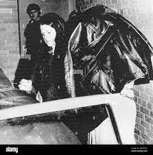 Robin Oswald, 17, of suburban St. Louis, emerges from the U.S. District  Court building in Benton, Ill., shrouded with a jacket and chained after  she was seized from a TWA jetliner she