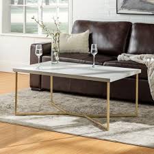 With an included shelf under the table, this table provides extra storage for magazines, table books, remotes, and more for easy organization. Faux Marble Y Leg Coffee Table With Gold Frame Coffee Table Rectangle Coffee Table Faux Marble Coffee Table