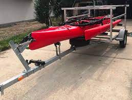 A kayak trailer easily tows behind most vehicles and typically requires a simple hitch and electrical connection to enable brake lights. North Woods Sport Trailers Hobie C Tandem Island Storage Kayaks Bikes Mast Tube Paddling Buyer S Guide