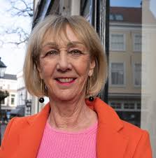 Orange leather skirt with a pink jumper in The Hague