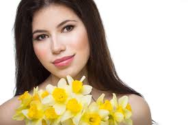 Beautiful young woman with daffodils