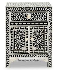 Delicate carved pieces of bone have been individually inlaid onto a bedside table wooden in an elaborate geometric pattern. Bone Inlay Black Bedside Table Floral Design Bohemain Artefacts Bone Inlay Mother Of Pearl Bed Side Chest Of Drawers Mrrors End Tables Tray Boxes