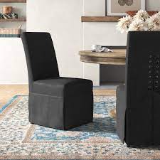 Pick your favorite base fabric, then customize it with your choice of welt, nailhead trim and casters. Skirted Dining Chair Birch Lane