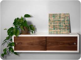 I really like the idea of a wooden floating shelf; 8 Wall Mounted Nightstands And Cabinets That Are Downright Magical Floating Cabinets Floating Shelves Shelves
