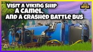 In the middle of an open field, there is a downed bus in a divot. Visit A Viking Ship A Camel And A Crashed Battle Bus Week 10 Season 6 All Locations Cute766
