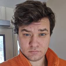 Smiling worker holding tomatoes in grocery store updated their profile  picture.