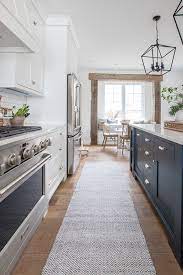 They added a huge window over the sink to bring in the outside view and natural lighting. Navy Island White Kitchen The Lilypad Cottage