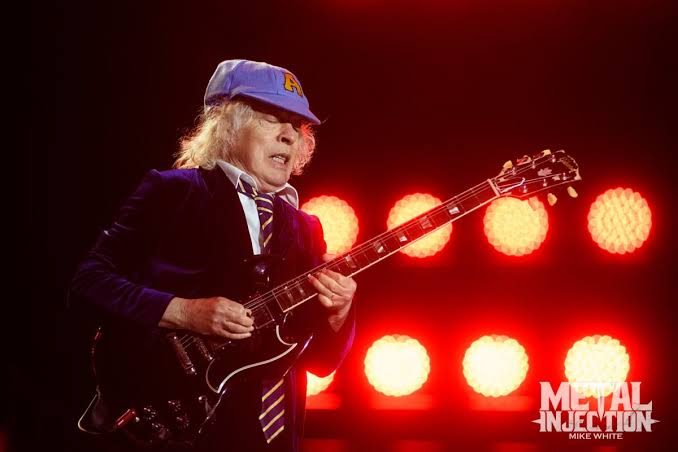 WATCH: AC/DC's Angus Young Autographs an Actual Baby - Metal Injection