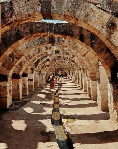 Beneath the stone vaults of ancient Smyrna, water still flows after 2,000  years. Inside the Agora of İzmir, this ancient channel still runs beneath  the Roman arches.