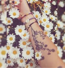 20 Pretty Tattoos That Channel An Inner Free Spirit Daisy Tattoo Daisy Tattoo Designs Whimsical Tattoos