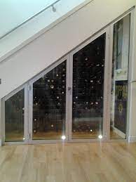Great Under The Stair Case Wine Cellar Created With Mercer Aluminum Windows Home Wine Cellars Wine Cellar Design Under Stairs