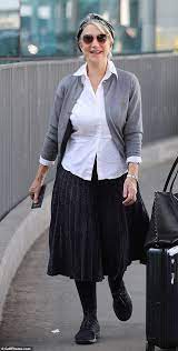 Helen Mirren, 74, cuts a chic figure in a grey pleated skirt as she touches  down in LA | Daily Mail Online