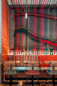 A Colorful Rope Mural Adds An Artistic Touch To This Restaurant Restaurant Design Cafe Design Restaurant Interior Design