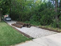 I've been getting busy lately and need more parking because vehicles are getting stuck in certain spots. Railroad Ties Might Be Cheaper Than Rock Or Stone And If Laid Properly Can Give The Function And Aesthetics Desired Rock Driveway Driveway Edging Diy Driveway