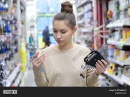 Working in a hardware store as a woman is awesome because every dude buying a stud finder. Young Woman Chooses Image Photo Free Trial Bigstock