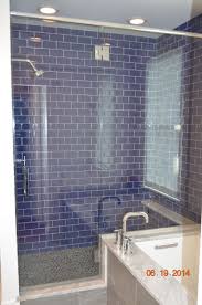 A stunning glass backsplash adds unique detail to any design. Walk In Shower With Cobalt Blue Glass Tiles Blue Glass Tile Glass Tile Bathroom Blue Glass Tile Bathroom
