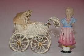What first emerged as a popular children's toy, antique porcelain dolls soon became a cherished collectible. Antique Dollhouse Pram With 2 Porcelain Dolls At 1900