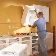 Prepare several single cabinets and then combine them together by placing them on a horizontal surface. How To Install Kitchen Cabinets Diy Family Handyman