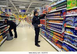 Workers Stock The Shelves And Check Prices In A Tesco Store Stock Image Supermarket Stacking Shelves Image