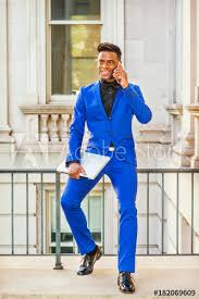 Check spelling or type a new query. African American Businessman Works In New York Wearing Blue Suit Black Shirt Bow Tie Leather Shoes Holding Laptop Computer Black Man Sits On Railing In Office Building Talks On Cell Phone Stock