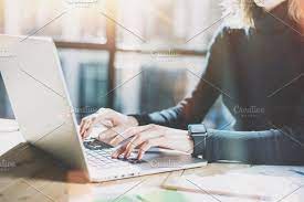 Work Process In Modern Office Young Account Manager Working At Wood Table With New Business Project Typing Contemporary Laptop Keyboard Wearing Smartwatch Hor Modern Office Film Effect Wood Table