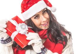 Christmas gift baskets & gift delivery. Woman In Christmas Hat Shakes The Xmas Present Curious Of Stock Photo Crushpixel