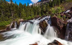 A waterfall is a place where flowing water rapidly drops in elevation as it flows over a steep region or a cliff. 15 Beautiful Waterfalls In Glacier National Park You Ll Want To See