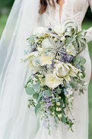 White wedding bouquets flower bouquet wedding wedding dresses one shoulder wedding wedding groom wedding gowns bride groom wedding bouquets wedding rings industrial the couple tied the knot at moli'i gardens at kualoa ranch, a mostmeghan and camion's lush, boho. Featured In The Knot Sylvia Daniel S Romantic Chicago Wedding Blue Wedding Bouquet Wedding Bouquets Wedding Flower Arrangements