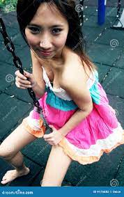 Cute Asian girl on a swing stock photo. Image of black 