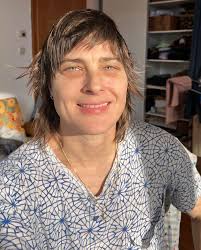 Desk and night reading shots, a “trans before and after” collage, a photo  from my childhood, 4 books I love (Grievers and Earthsea trilogy) some  shoes I love (Jean-Michel Basquiat skulls on