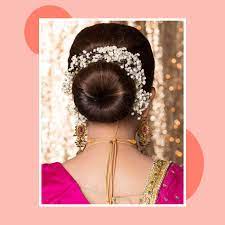 While subtle hair accessories beautify the hairstyle, the messy updo and minimal side swept bangs create an illusion of an elongated face. Prettiest Reception Hairstyles For Saree Lehenga Gown Nykaa S Beauty Book
