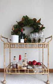 This preppy pink station is decorated with fresh flowers and accented with a bright blue parasol. How To Style A Bar Cart For Any Season Julie Blanner