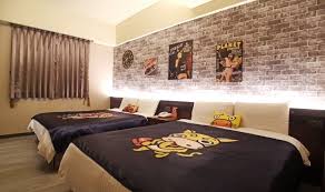 Music themed pink girls bedroom with music notes across the wall and faux canopy bed. Room Monster Village Hotel