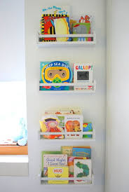 We attached the poster first, since it was the base we would be working out from on either side. Cozy Creative Ways To Display Books In The Nursery