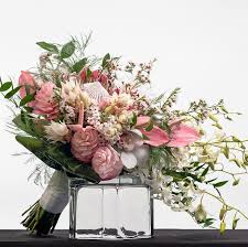 Unlike more traditional weddings on land, seaside ceremonies typically offer a more relaxed feel. Soft Tropical Collection Bridal Bouquet By Watanabe Floral Inc