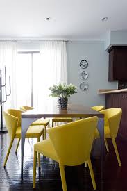 White decorating creates bright kitchens and dining rooms, neutral colors bring comfort, and colorful accents add interest to the decor. Canary Yellow Dining Chairs At Metal And Wood Table Contemporary Dining Room
