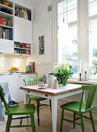 Green Painted Wooden Kitchen Side Chairs With A Table With White Legs And Wooden Surface In A Kitc Dining Room Small Small Dining Room Table Dining Room Design